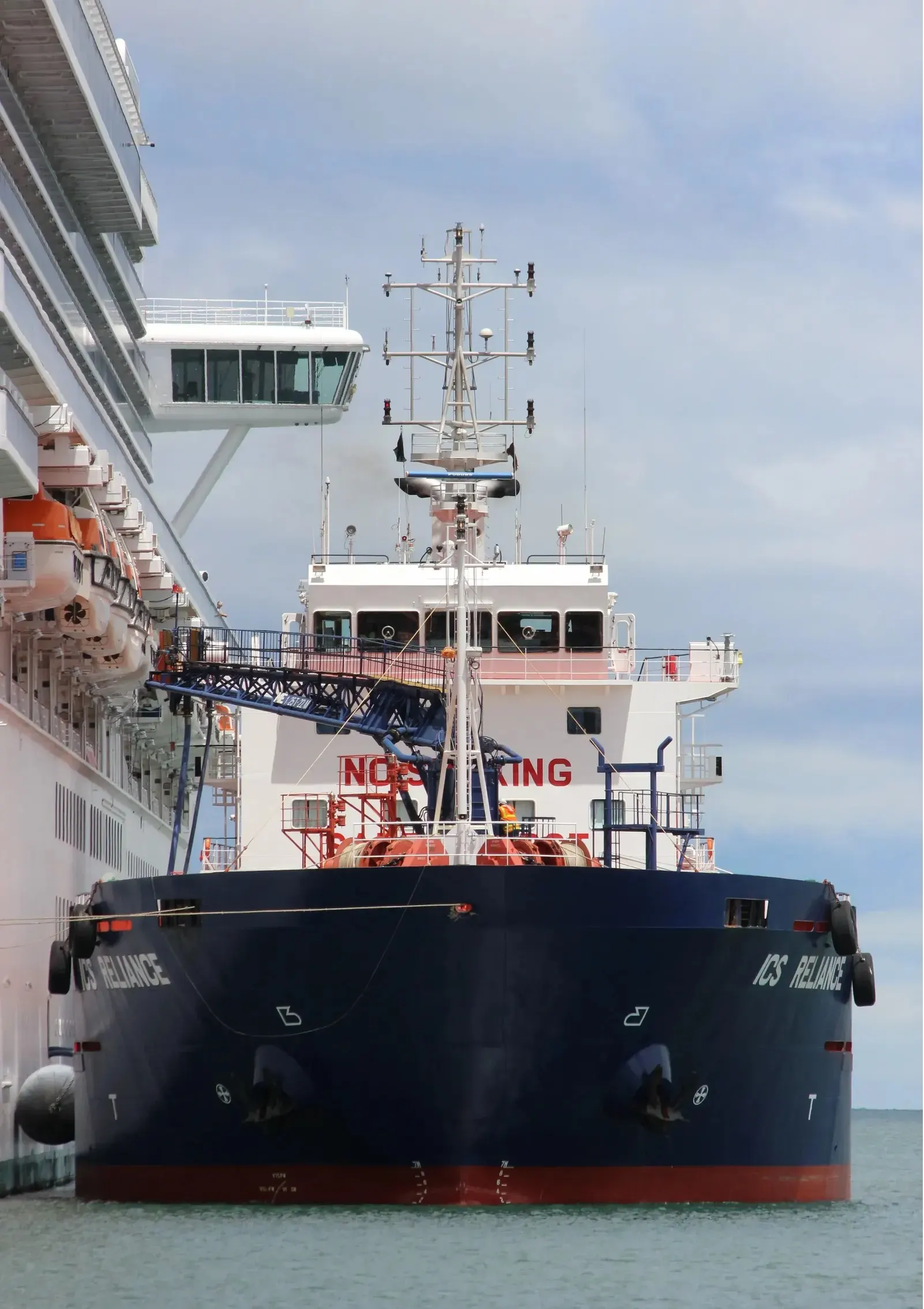 ICS Reliance alongside a cruise ship, her bunkering boom rigged across to the vessel she is fuelling.