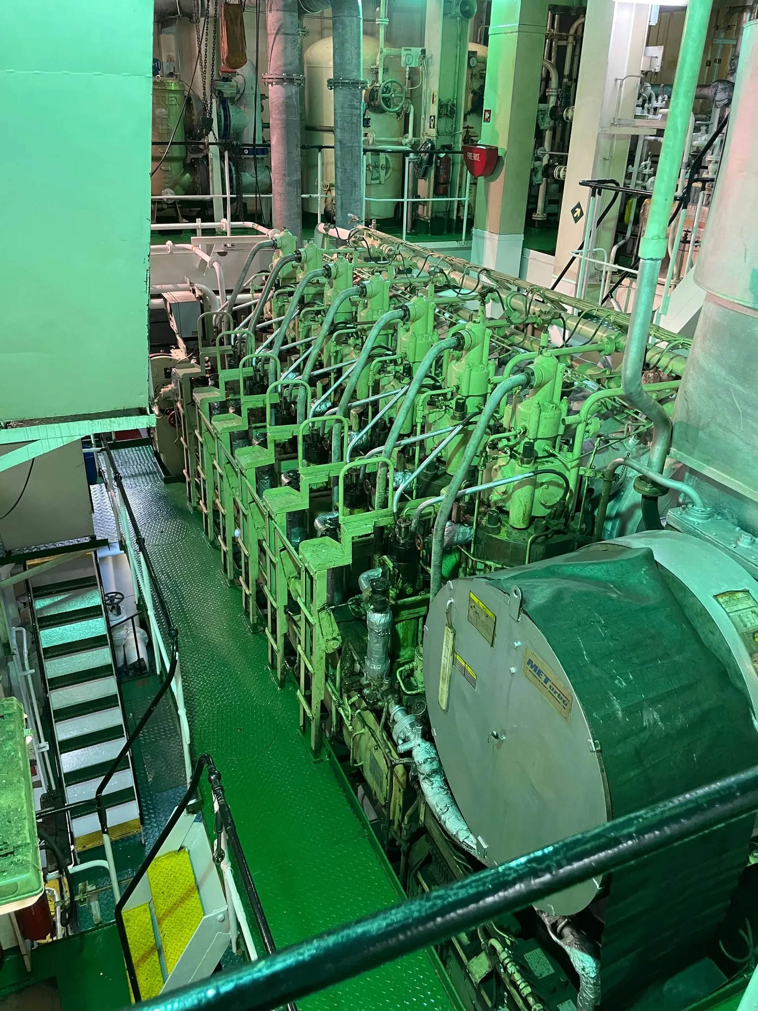 The main engine's cylinder heads in a row, seen from the upper plates of the engine room.